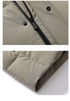 Close-up of light beige puffer jacket front closure showing black zipper, snap button placket and precision stitching details
