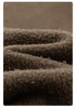 Macro detail of dark brown fleece material showing fuzzy interior texture and plush surface
