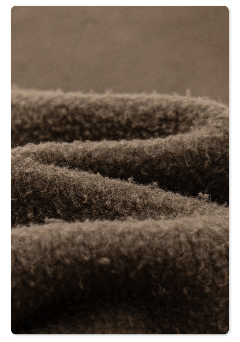 Macro detail of dark brown fleece material showing fuzzy interior texture and plush surface