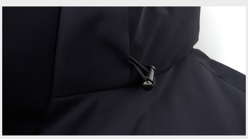 Adjustable hood drawstring on a black puffer coat, designed for a customizable fit and added protection against wind and cold