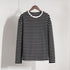 Black and white striped long-sleeve shirt hanging on wooden hanger