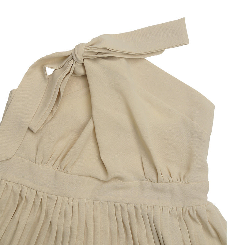 Close-up detail of cream halter dress neckline showing gathered fabric and tie closure