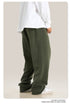 Close-up of olive green sweatpants waistband showing white drawstring detail and fabric texture