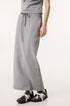 Long light gray denim skirt with soft drape and drawstring waist, worn with gray and black sneakers