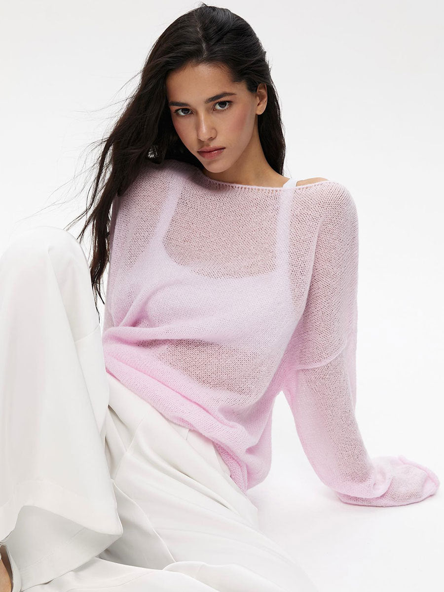 Light pink semi-sheer knit sweater with boat neckline and dropped shoulders, white camisole visible underneath