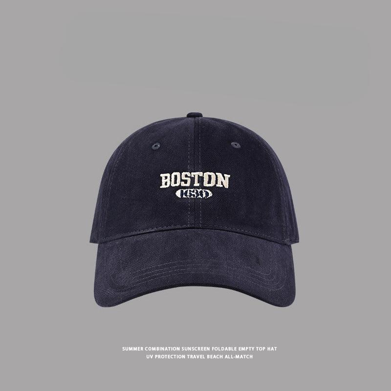 Navy blue Boston embroidered baseball cap with classic fit, UV protection beach hat against gray background