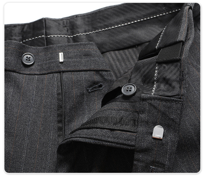 Trouser closure detail with button, hook fastening and quality hardware on pinstripe fabric
