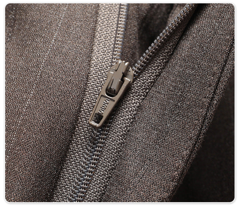 Detail shot of gray suit trouser zipper and closure system