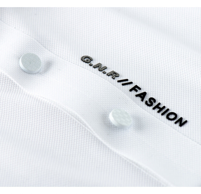Detail of G.N.R. FASHION vertical text branding on white polo shirt placket with matching buttons