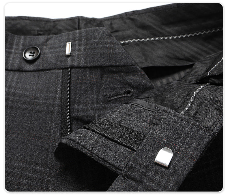 Trouser waistband detail showing button closure and quality tailoring elements