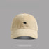 Beige baseball cap with small black bear embroidery - A neutral beige dad hat with a subtle black bear emblem stitched at the center