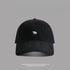 Black baseball cap with small white bear embroidery - A sleek black dad hat with a tiny white bear logo embroidered on the front