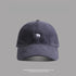 Navy blue baseball cap with small white bear embroidery - A dark navy dad hat featuring a small embroidered white bear logo