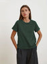 Dark Green T-Shirt Outfit – Model in a dark green short-sleeve T-shirt tucked into black trousers
