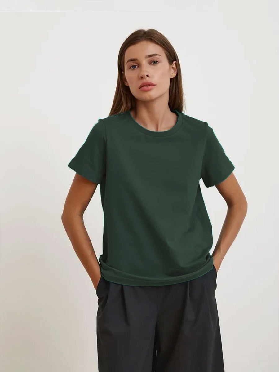 Dark Green T-Shirt Outfit – Model in a dark green short-sleeve T-shirt tucked into black trousers