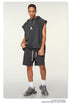 A model wearing charcoal sleeveless hoodie with matching shorts, silver pendant necklace and gray athletic shoes against white background