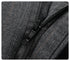 Close-up of black zipper detail on dark pinstripe wool trouser material