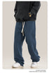 Close-up of gray sweatpants fabric showing texture and stitching detail along the hem