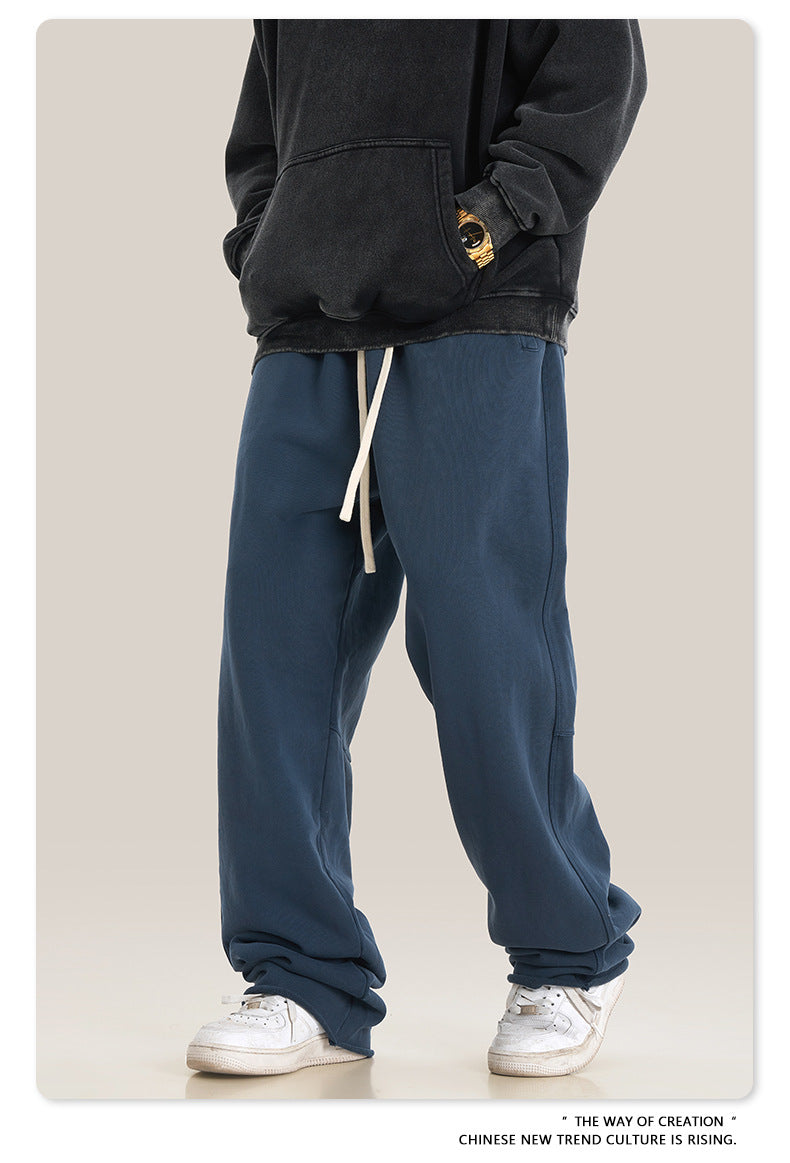 Close-up of gray sweatpants fabric showing texture and stitching detail along the hem