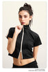 Black crop top with white zip front, mock neck, short sleeves, white side stripes