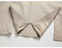 Center vent detail of beige suit jacket showing expert tailoring and drape