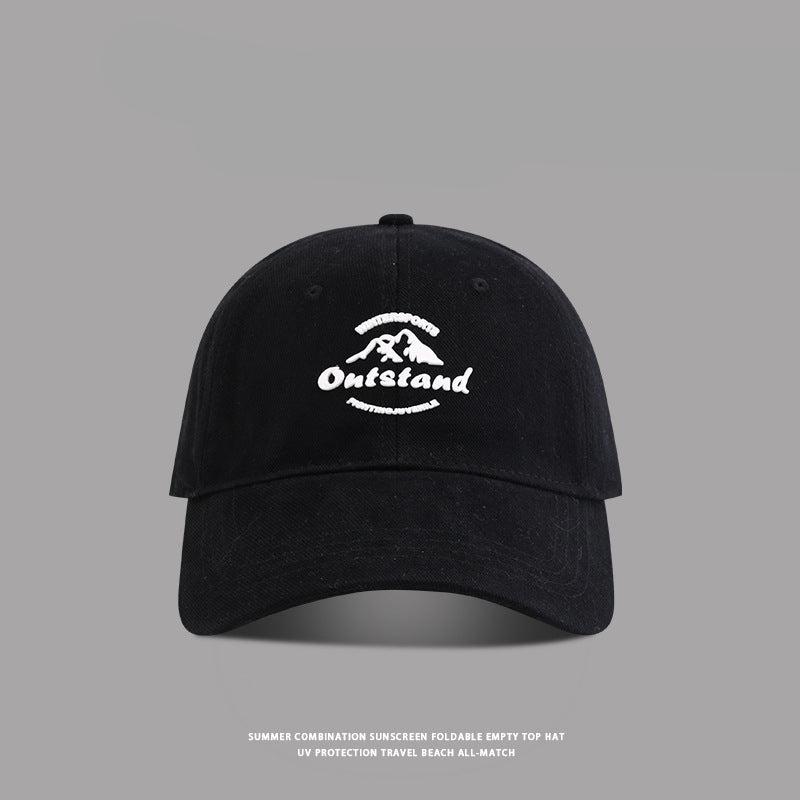 Black baseball cap with "Outstand" and a mountain logo embroidered in white
