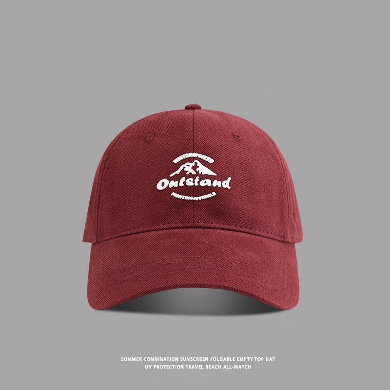  Brick red baseball cap with white "Outstand" embroidery