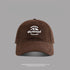 Chocolate brown baseball cap featuring white "Outstand" and mountain logo embroidery