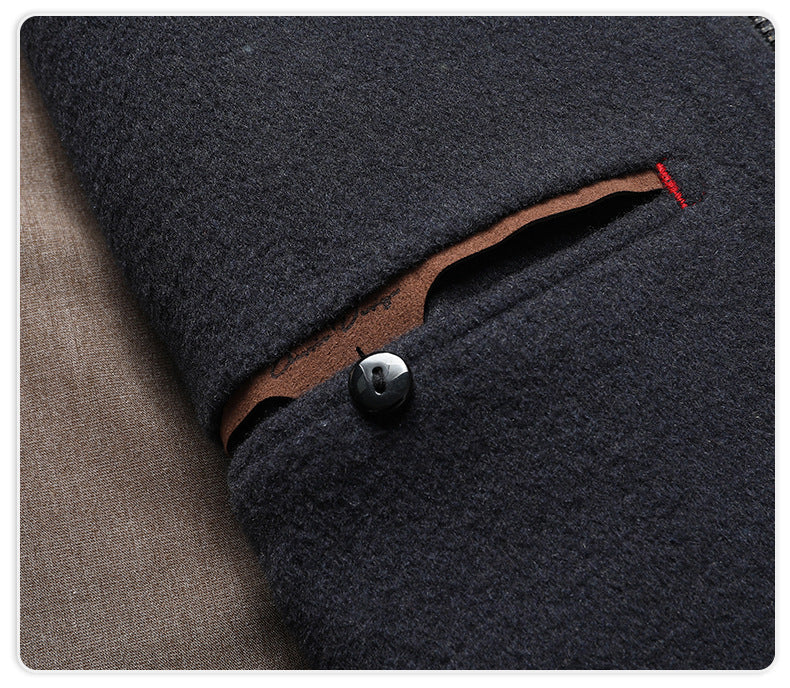 Close-up of navy wool jacket pocket with button closure and contrasting brown lining