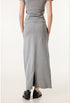 Rear view detail of long gray denim skirt showing center back seam and waistline, with black sneakers