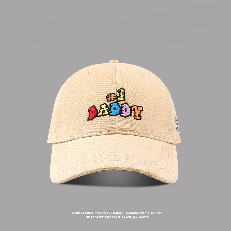 Light brown '#1 Daddy' embroidered baseball cap with multicolored text, curved brim, and vintage washed fabric