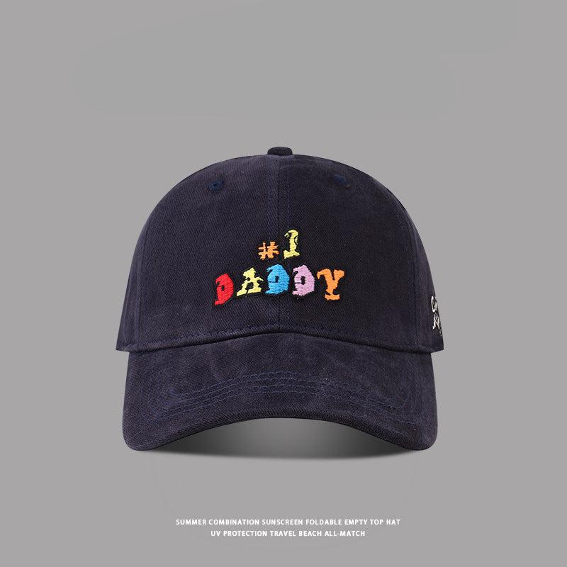 Navy blue '#1 Daddy' baseball cap featuring multicolored embroidery, curved brim, and adjustable back strap