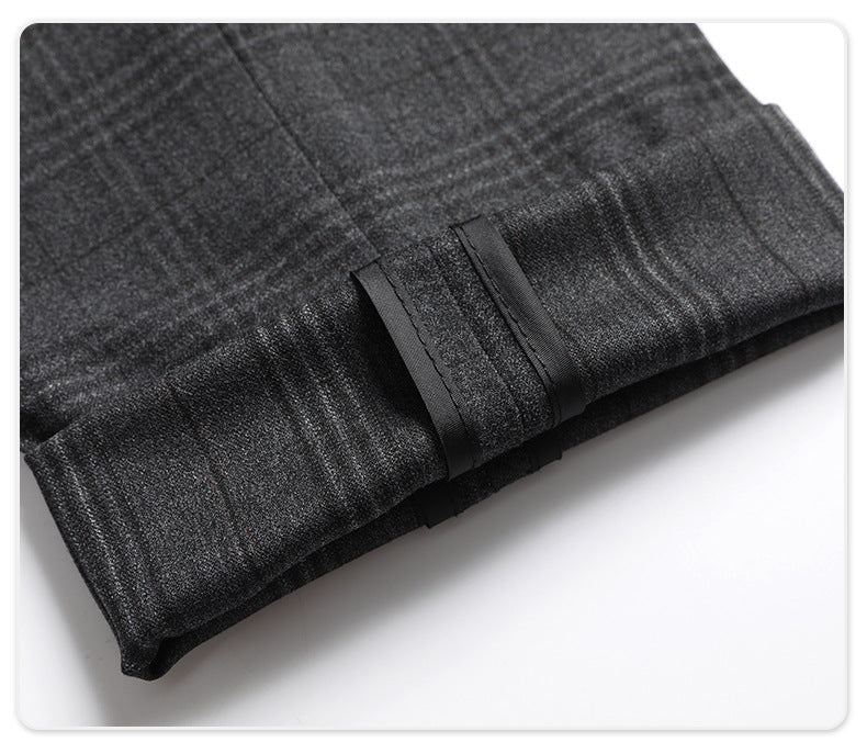 Hem detail showing inside finishing of charcoal plaid suit trousers