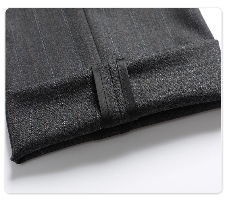 Hemline detail of trouser showing clean finishing with satin trim on pinstripe fabric