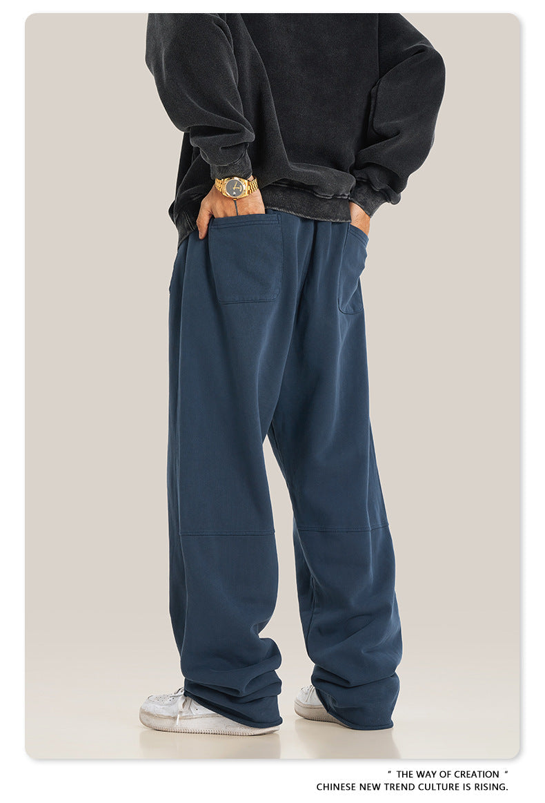 Close-up of gray sweatpants showing fabric texture and edge stitching detail