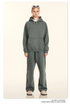 Model wearing sage green oversized hoodie and sweatpants set with cream slip-on shoes on neutral background