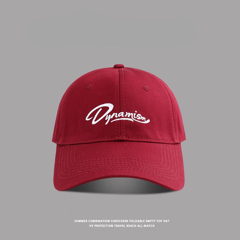 Wine red baseball cap featuring white Dynamism logo embroidery