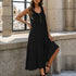 Black midi dress with gold buttons, model near window with white building backdrop, wearing black high heels