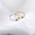 Gold and silver eye rings with blue sapphires displayed together on white background