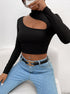 Detailed view of black long-sleeve crop top with unique cutout design and mock neck