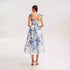 Back view of blue and white floral organza dress, highlighting delicate bow straps and fitted bodice