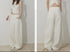 Side-by-side front and back views of white high waist wide-leg denim pants.