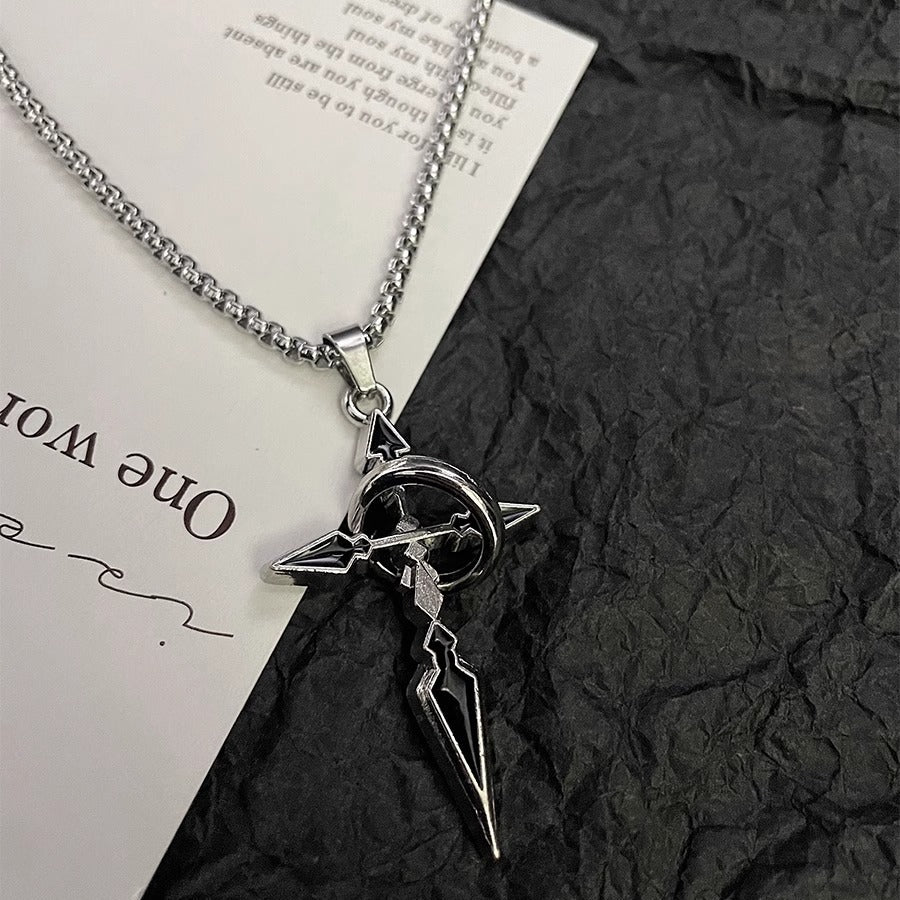 Silver gothic-style cross pendant with circular center detail on box chain displayed on paper against black textured surface