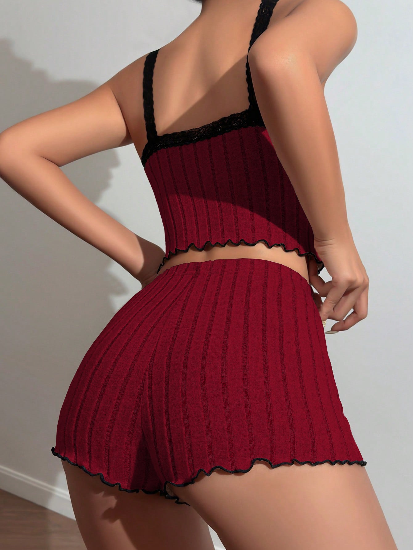 Back view of burgundy ribbed sleep set showing scalloped hem detail and black lace straps