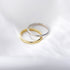 Gold and silver 925 stackable band rings overlapping on white satin surface in studio lighting