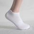White athletic ankle sock on mannequin foot displaying arch support band