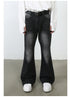 Front view of model wearing white oversized shirt, black triple-ring belt and black wide-leg jeans with diagonal seam detail