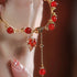 Elegant red agate bracelet with maple leaf charm and gold-tone details