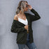 Casual outfit with army green cardigan, white crop top, and distressed denim