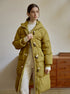 Long olive down coat featuring white toggle closures and utility pockets, styled with cream knitwear